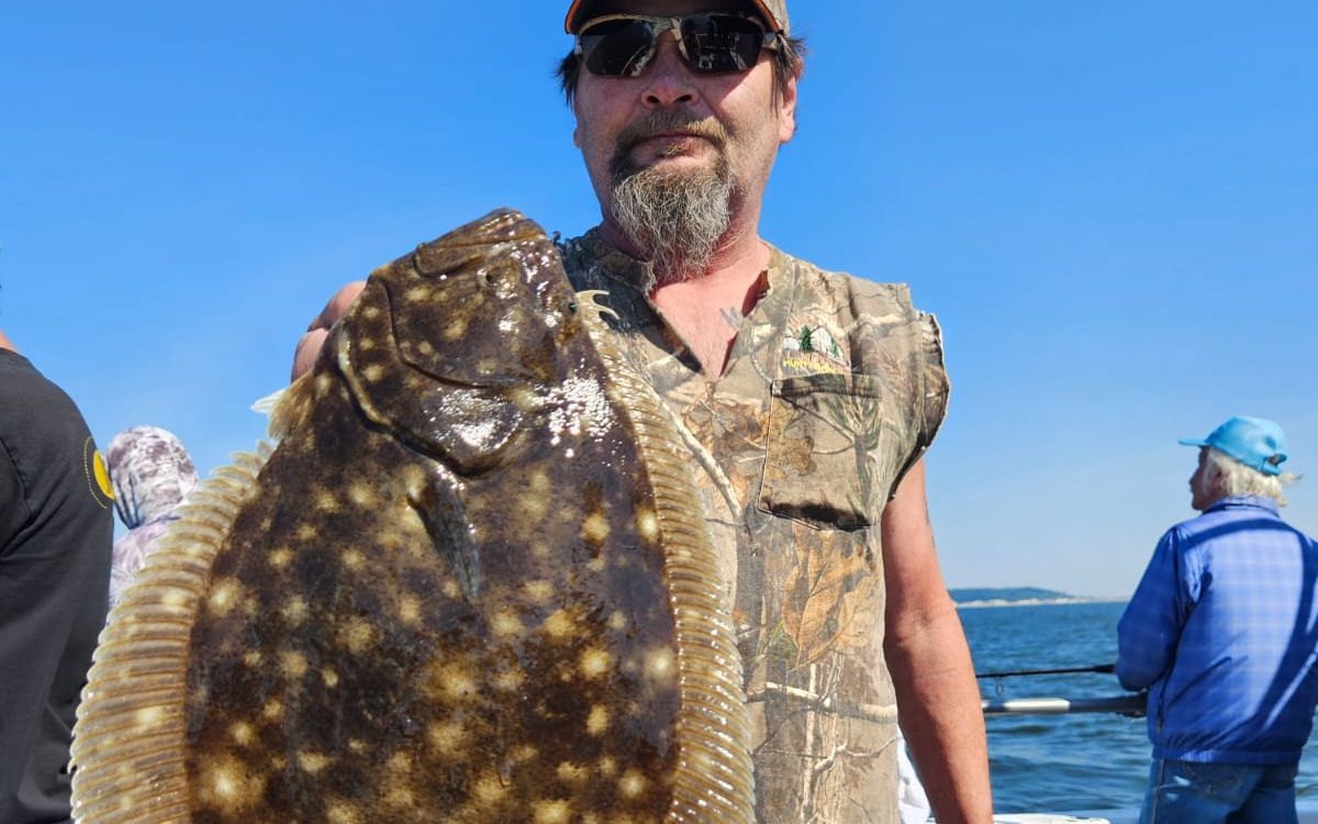 Angler holding a big fluke