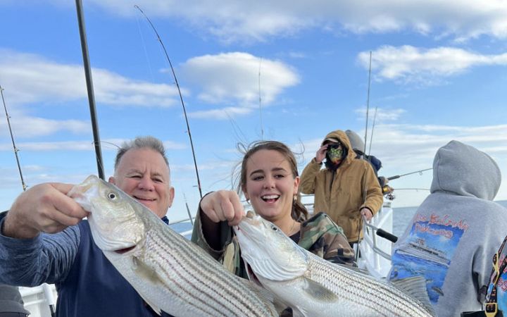 Anglers showing off striped bass on the 3/4 day trip